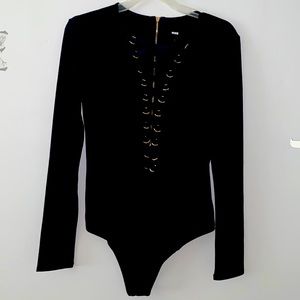 Body suit with ribbons and rings criss cross down the front zipper back closure.